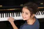 Girl at Piano looking over shoulder