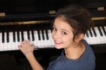 Girl at Piano looking over shoulder