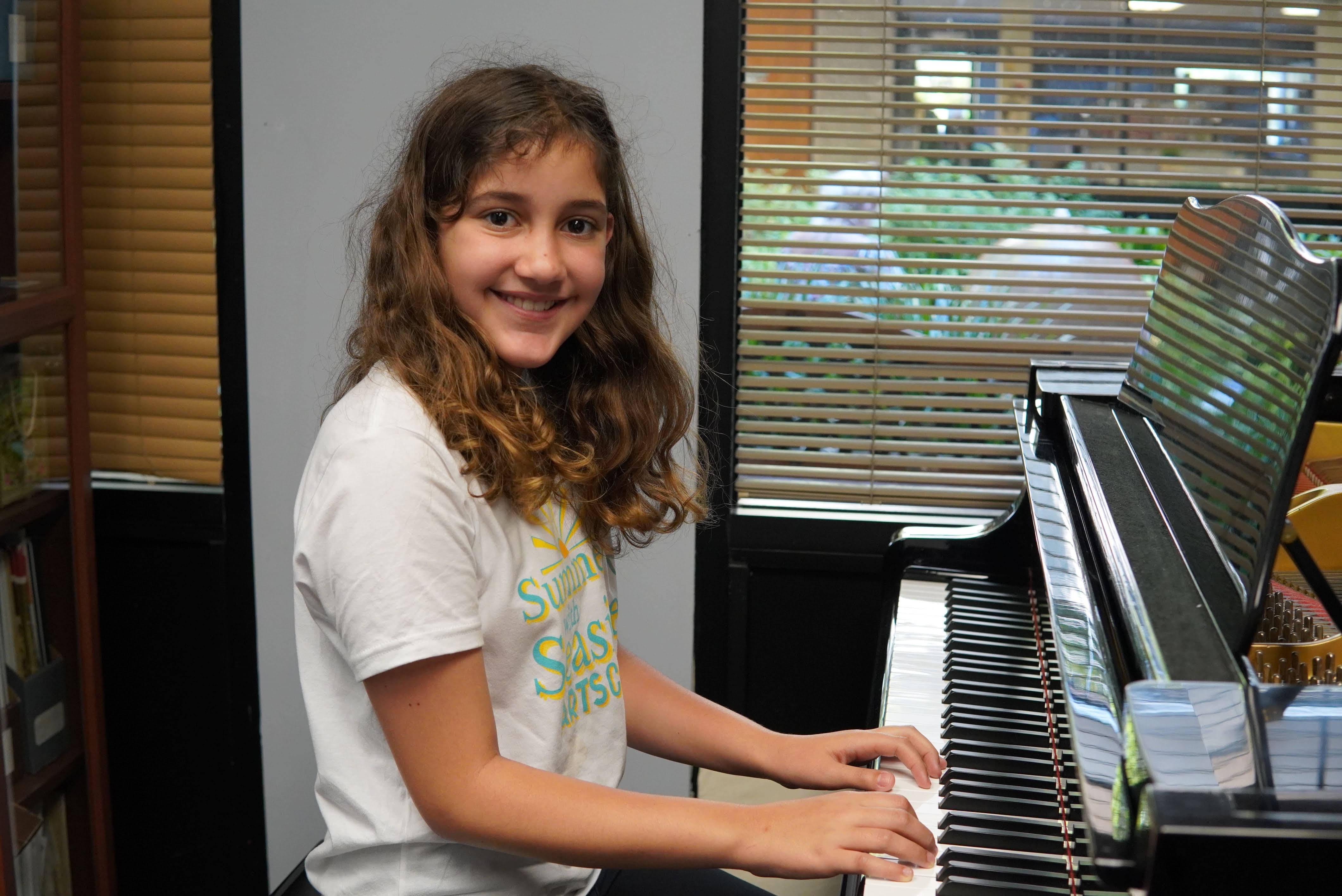 Smiling girl at piano