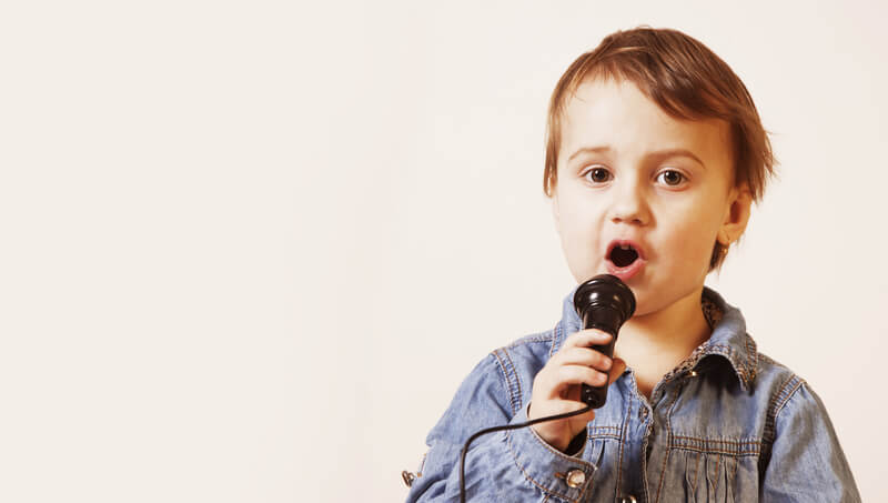 Little boy singing with mic