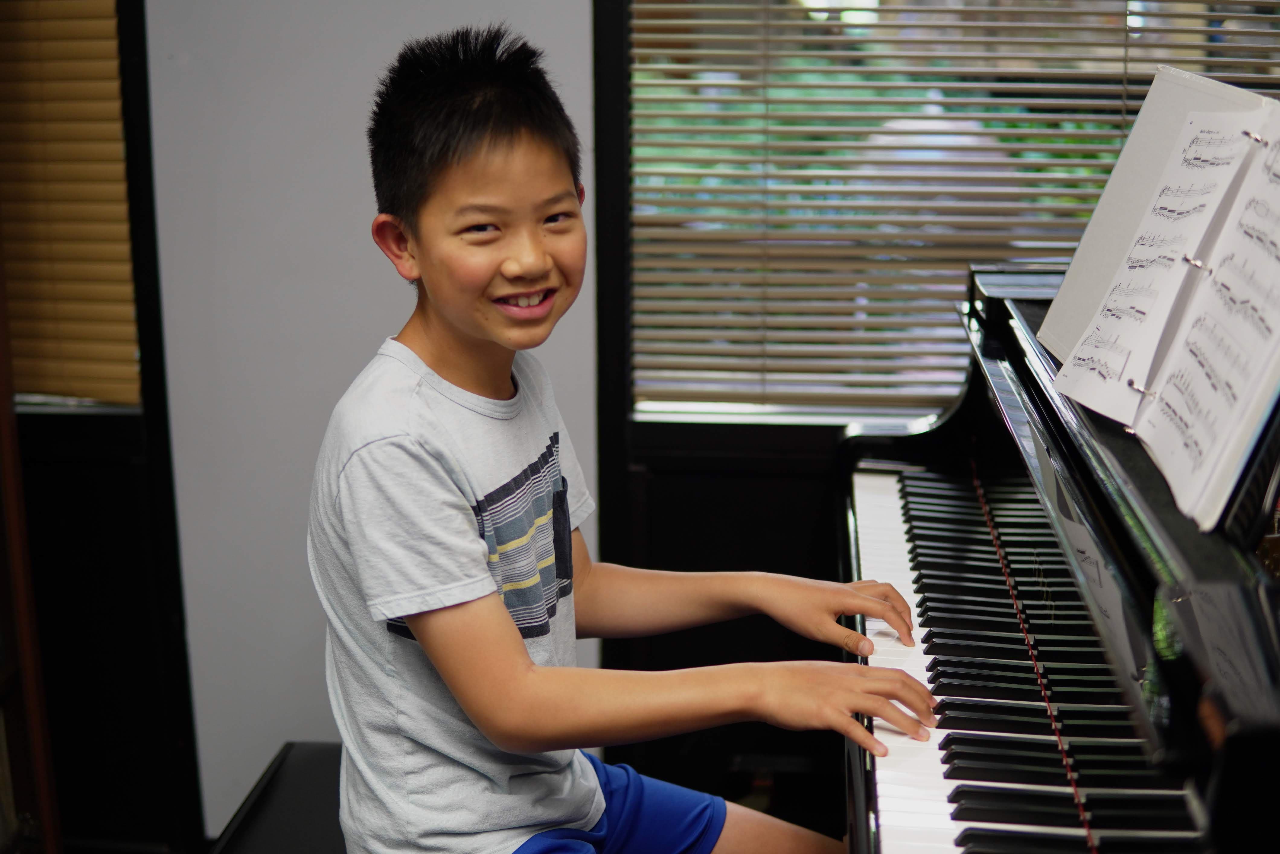 Smiling boy at piano