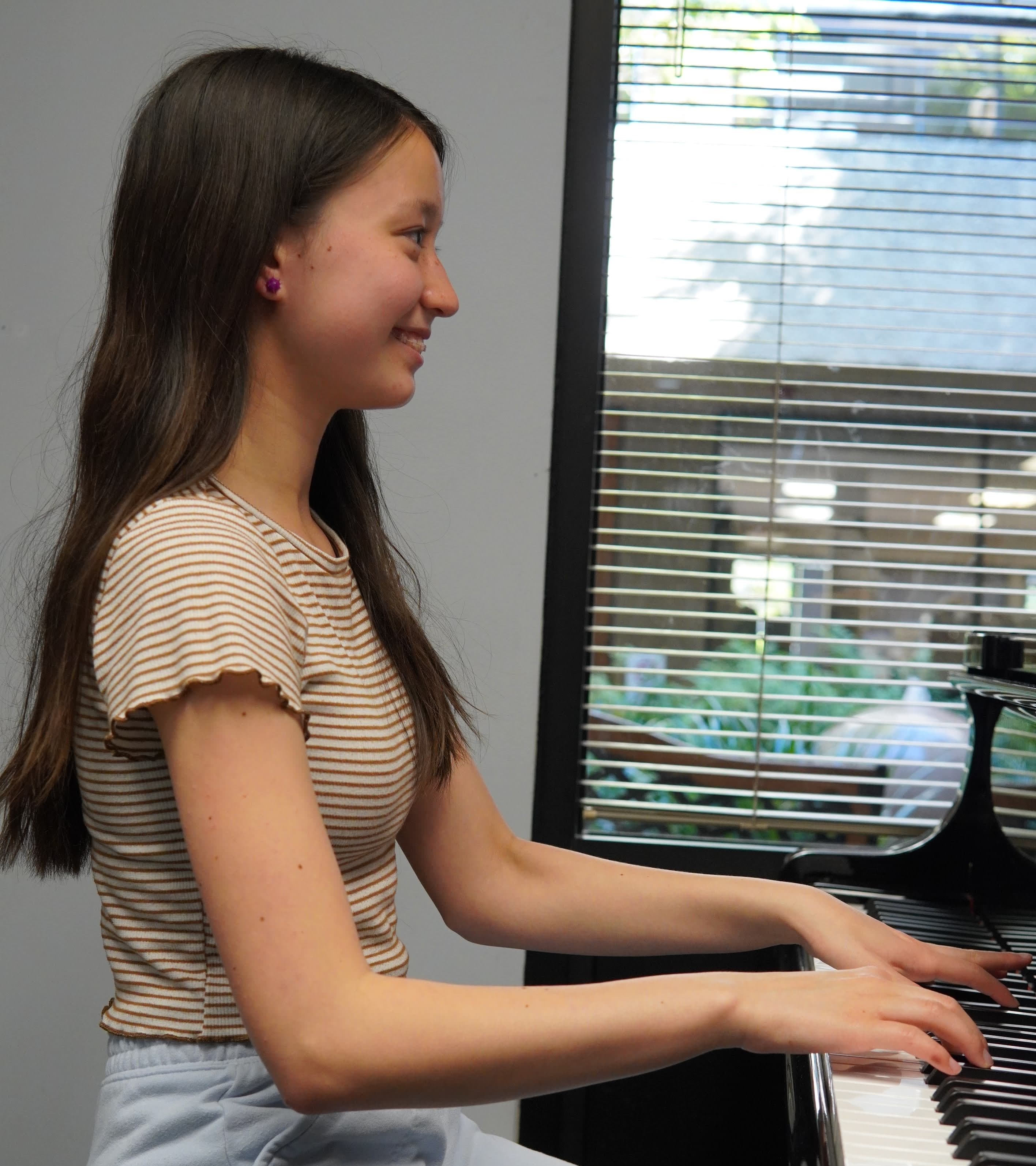 Smiling girl at piano