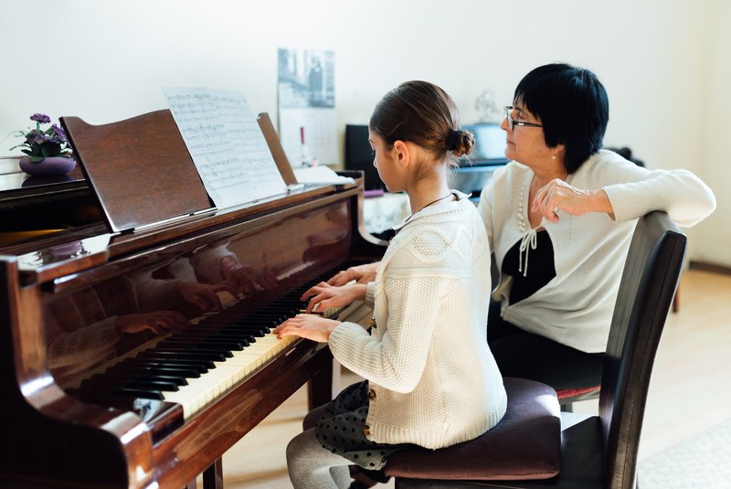 A piano lesson - student and teacher